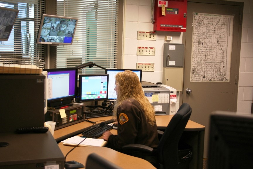 Woman taking a 911 call - side view